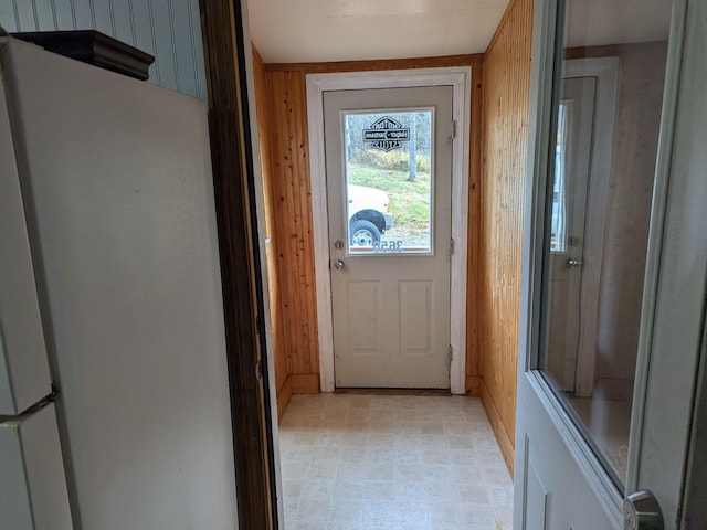 doorway with wood walls