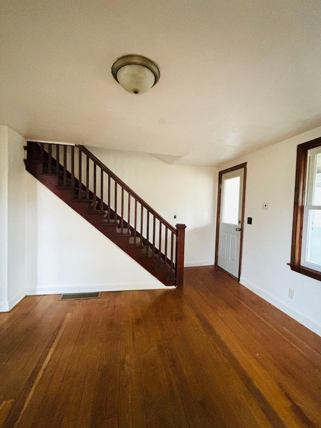 entryway with dark hardwood / wood-style flooring