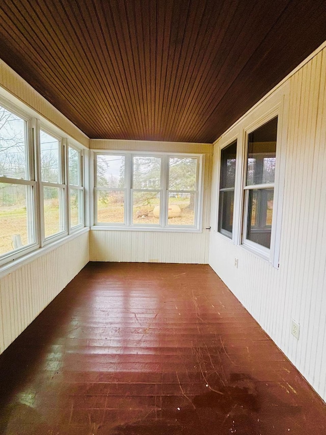 unfurnished sunroom with wood ceiling