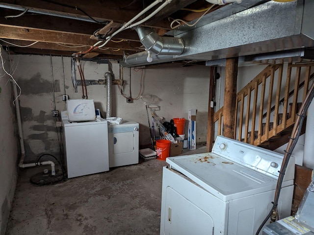 clothes washing area featuring separate washer and dryer