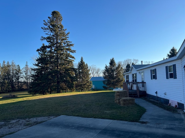 view of yard featuring a patio area and a wooden deck