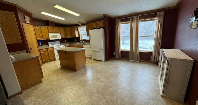 kitchen featuring sink, a textured ceiling, vaulted ceiling, white appliances, and a kitchen island