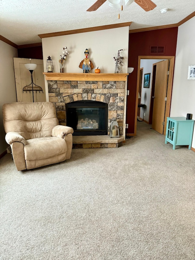 living room with a stone fireplace, carpet floors, a textured ceiling, and ornamental molding