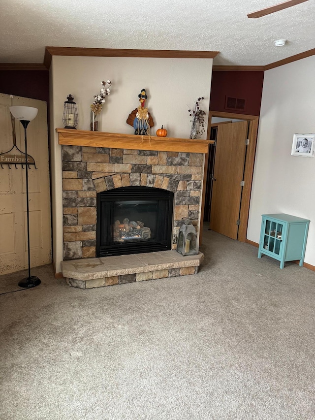 carpeted living room featuring a fireplace, a textured ceiling, ceiling fan, and ornamental molding