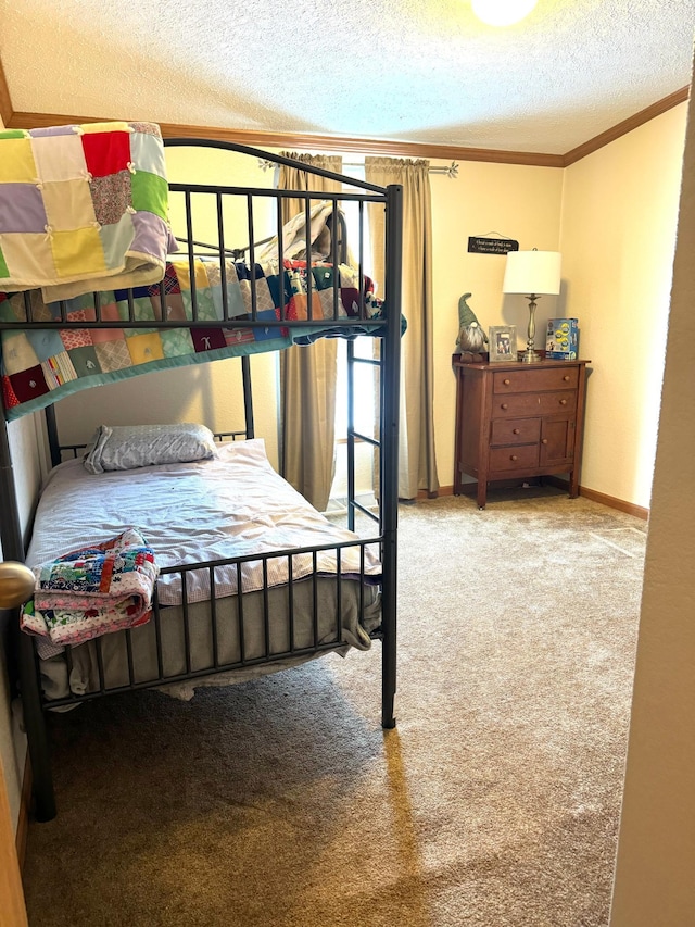 bedroom with a textured ceiling, carpet floors, and ornamental molding