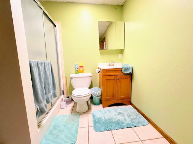 bathroom with toilet, tile patterned flooring, an enclosed shower, and vanity