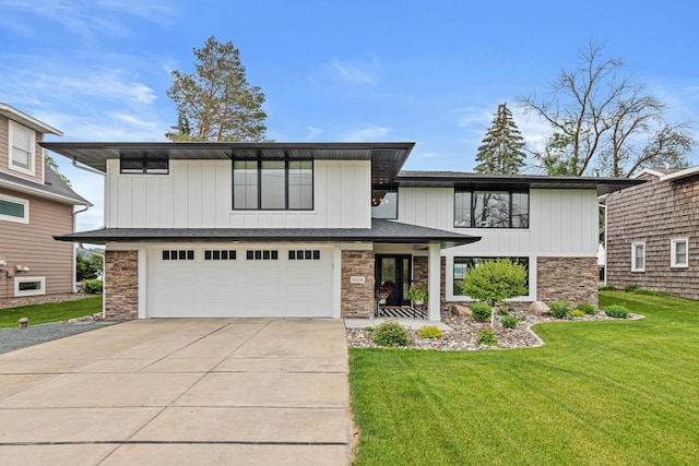 804 County Road I W, Shoreview, MN 55126 - view of front facade with stone siding, concrete driveway, a front yard, and an attached garage