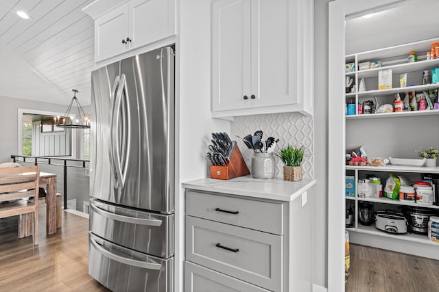 804 County Road I W, Shoreview, MN 55126 - kitchen with freestanding refrigerator, light wood finished floors, backsplash, light stone counters, and wood ceiling