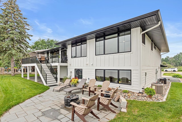 804 County Road I W, Shoreview, MN 55126 - rear view of property featuring an outdoor fire pit, stairs, a patio, a yard, and board and batten siding