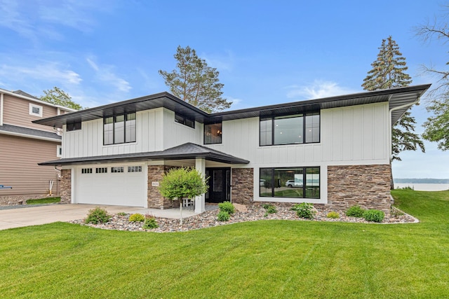 804 County Road I W, Shoreview, MN 55126 - view of front of house with stone siding, concrete driveway, a garage, and a front lawn
