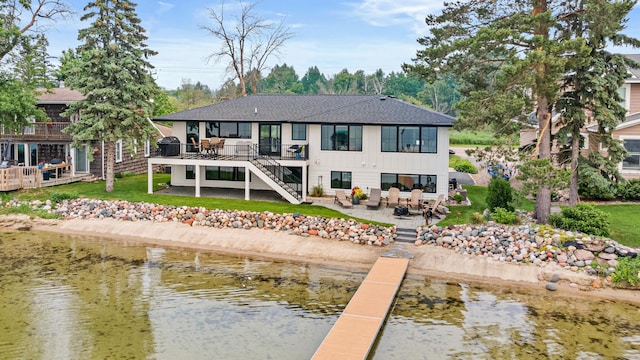 804 County Road I W, Shoreview, MN 55126 - rear view of property featuring a patio, a shingled roof, outdoor dining area, a deck with water view, and stairs