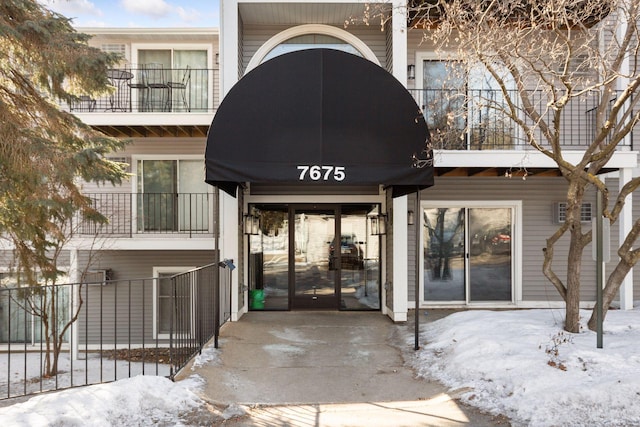 view of snow covered property entrance