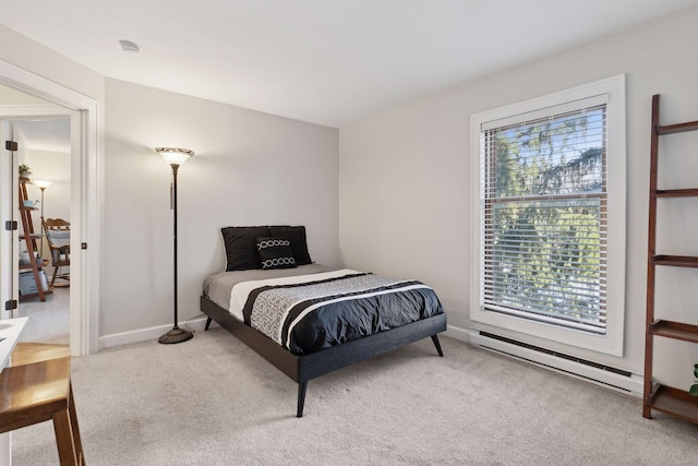 carpeted bedroom featuring baseboards and a baseboard radiator