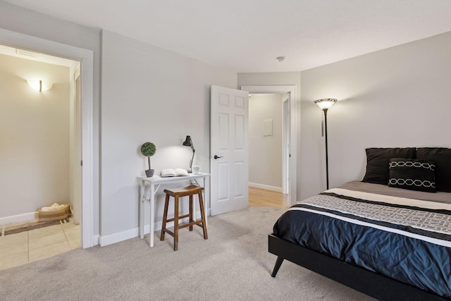 bedroom with baseboards and carpet flooring