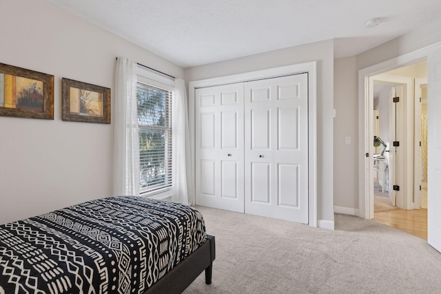 bedroom with a closet, carpet floors, and baseboards