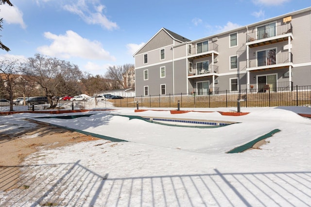 view of property's community featuring a residential view and fence