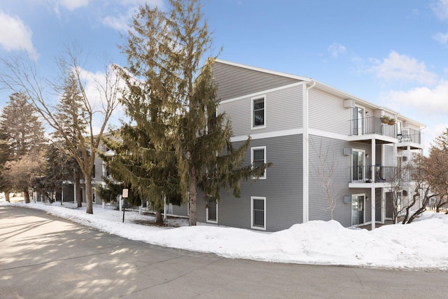 view of snowy exterior with a balcony