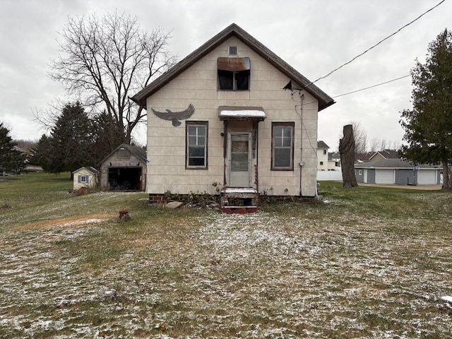 rear view of property with a storage shed and a yard