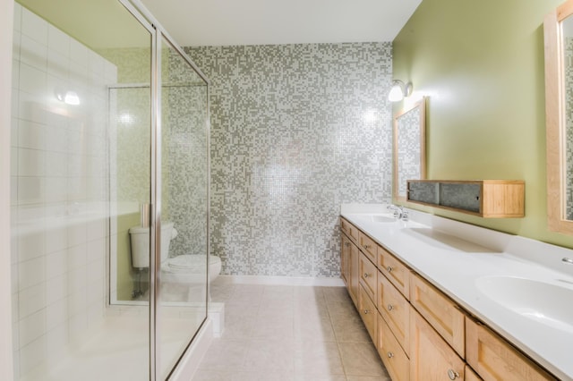 bathroom featuring tile patterned floors, vanity, toilet, and walk in shower