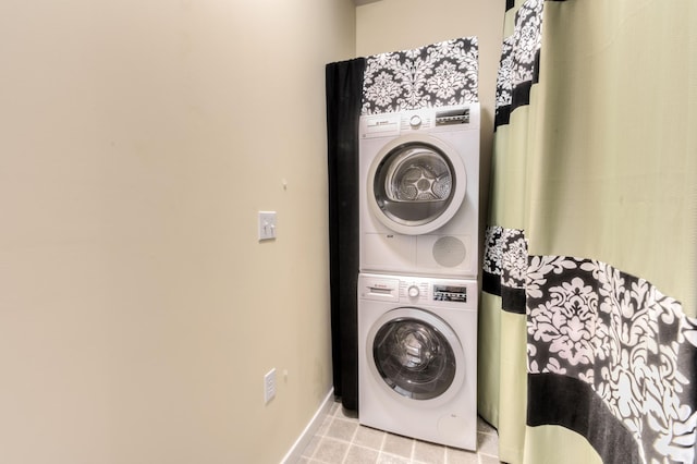 clothes washing area featuring stacked washer / dryer