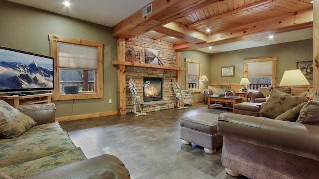 living room featuring beam ceiling, a stone fireplace, and wooden ceiling