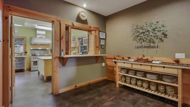 interior space with wall chimney range hood