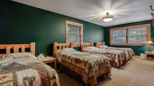 carpeted bedroom featuring a textured ceiling