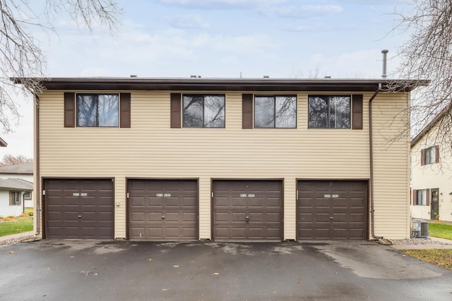 exterior space with central AC and a garage