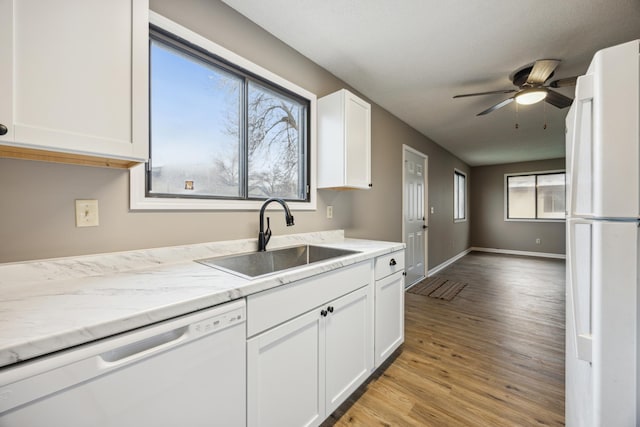 kitchen featuring white cabinetry, sink, ceiling fan, light hardwood / wood-style floors, and white appliances