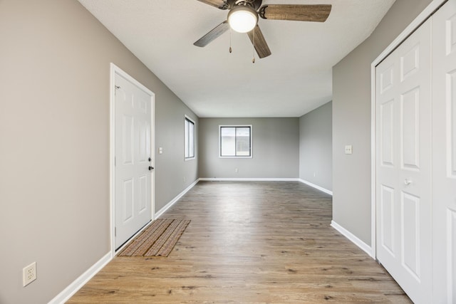 unfurnished room with ceiling fan and light wood-type flooring