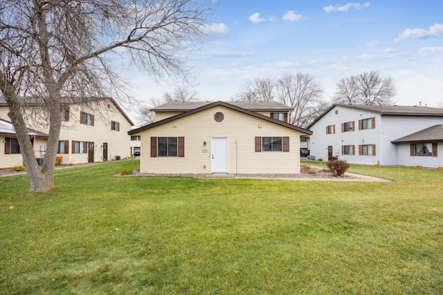 rear view of property featuring a yard