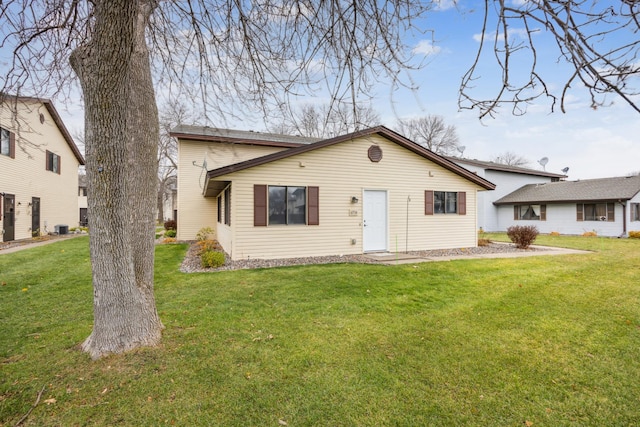 ranch-style home with a front yard and cooling unit