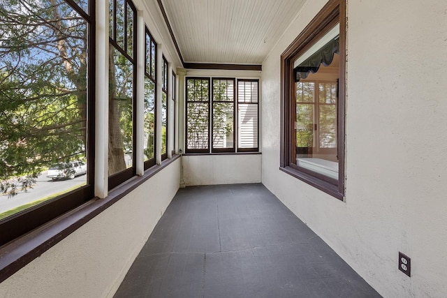 unfurnished sunroom with wooden ceiling