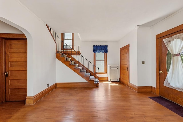 entryway featuring hardwood / wood-style floors and ornamental molding