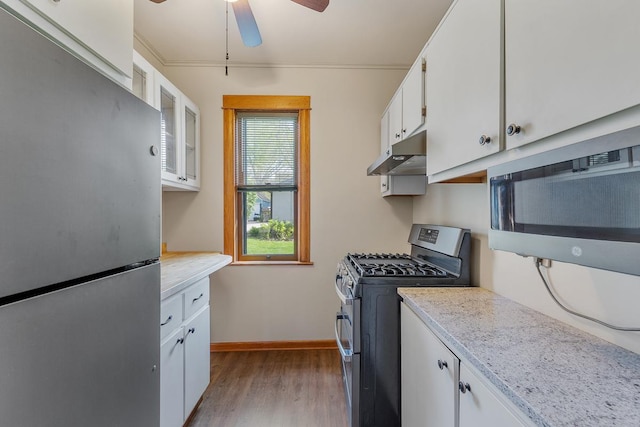 kitchen featuring light stone countertops, ceiling fan, light hardwood / wood-style floors, white cabinets, and appliances with stainless steel finishes