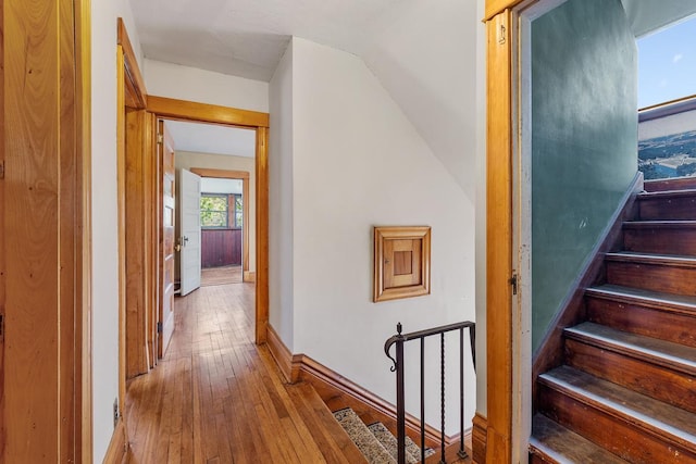 hallway with light hardwood / wood-style floors