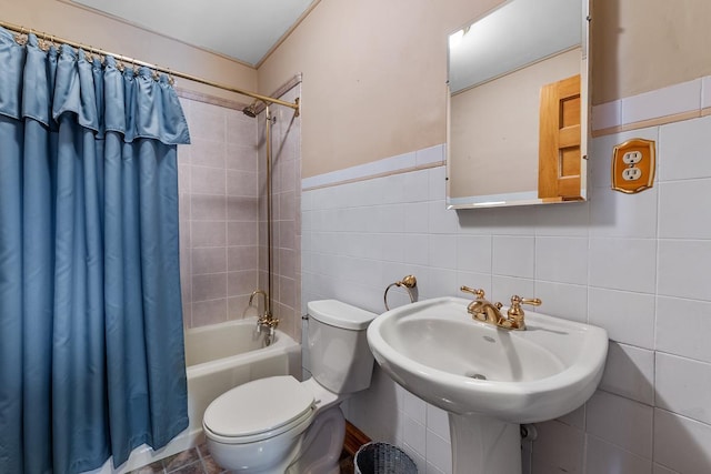 full bathroom featuring shower / tub combo, toilet, tile walls, and sink