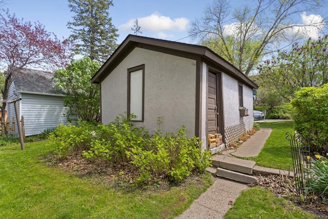 view of property exterior with a yard and a shed