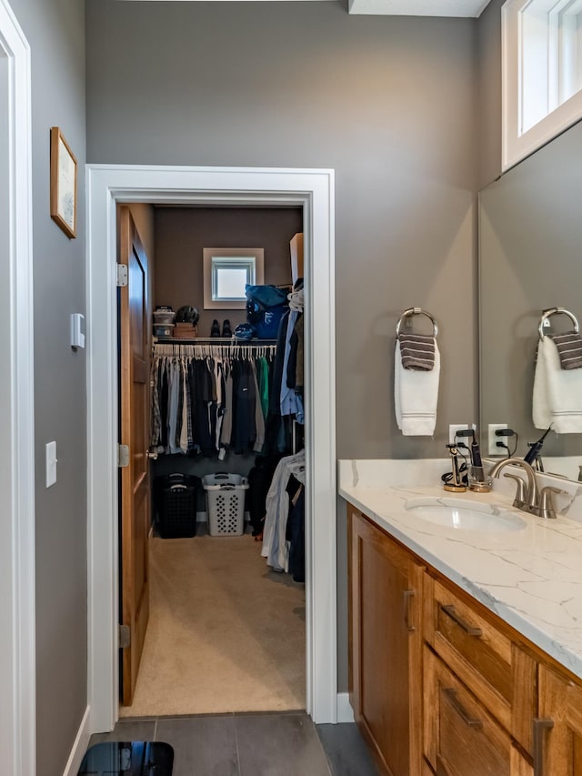 bathroom with vanity, tile patterned floors, and a wealth of natural light