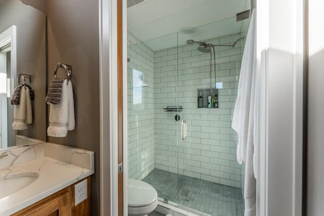 bathroom with vanity, toilet, and a shower with shower door