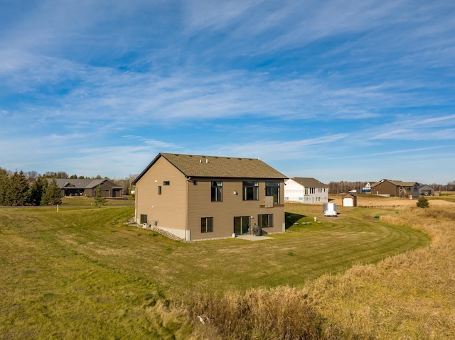 rear view of property featuring a yard