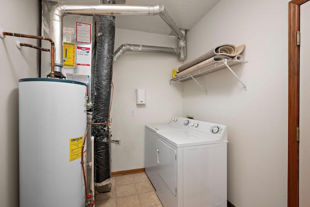 washroom featuring a textured ceiling, gas water heater, and washer and clothes dryer