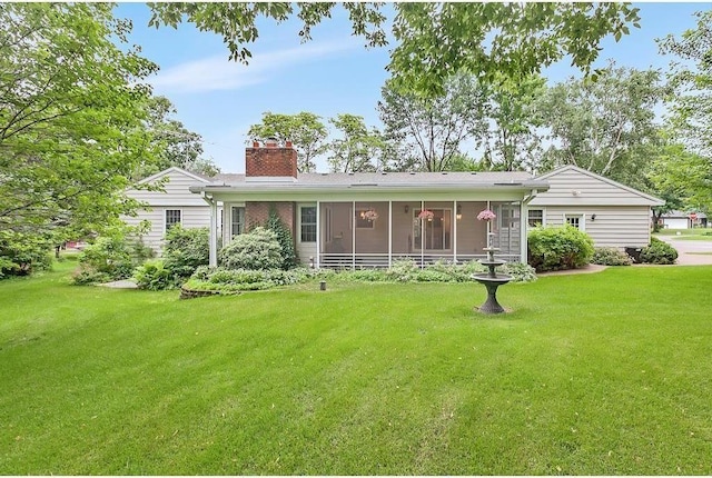 view of front of home featuring a sunroom and a front lawn