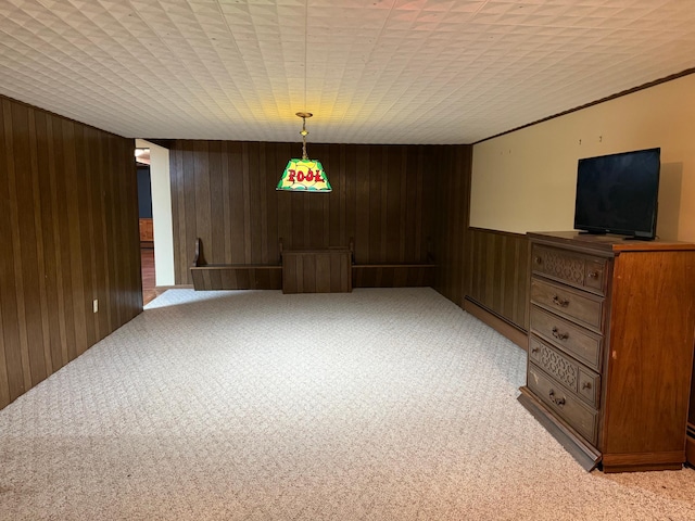 interior space featuring wood walls, light carpet, and a baseboard heating unit