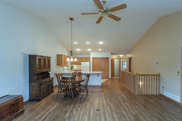 dining area with wood-type flooring, ceiling fan, and lofted ceiling