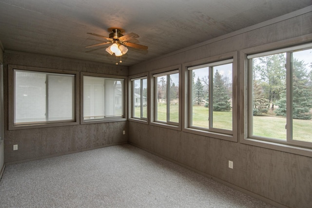 unfurnished sunroom with a wealth of natural light and ceiling fan