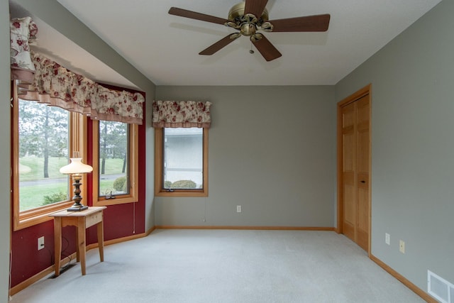 carpeted empty room with ceiling fan