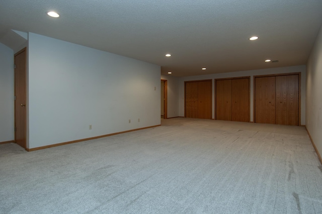 carpeted empty room with a textured ceiling