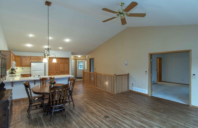 dining space featuring ceiling fan, dark hardwood / wood-style flooring, and high vaulted ceiling