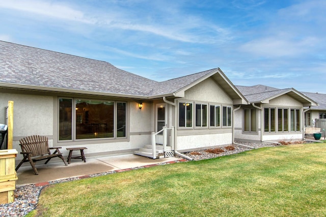 back of property with a yard and a patio area